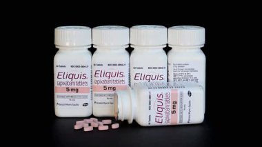Vadnais heights, MN. USA. August 20, 2025. Still life of Eliquis heart medicine on a black background.  It is a prescription blood thinner used to prevent and treat blood clots.