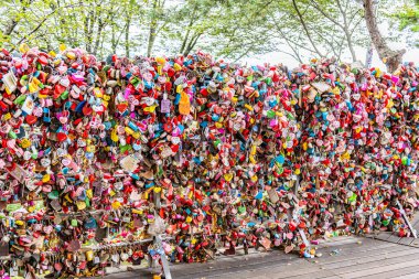 Editorial image showing a corner filled with colorful heart-shaped love locks at N Seoul Tower in Seoul, South Korea, symbolizing love, unity, and lasting promises shared by couples from around the world