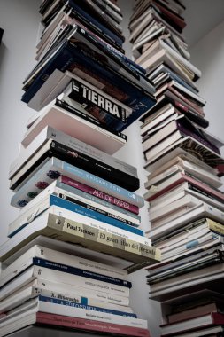 books piled up on a shelf, Mallorca, Balearic Islands, Spain