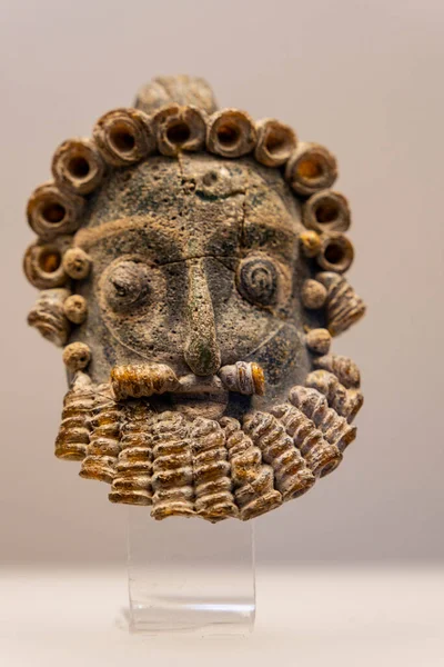 stock image pendant in the shape of a bearded male, from Carthage, 4th-3rd cent. BCE, Carthage National museum, The Coliseum ,   Rome, Lazio, Italy ,