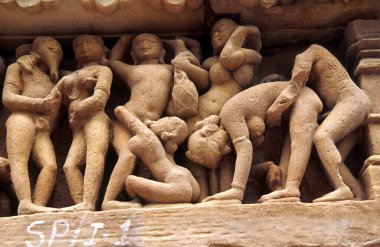 Erotic relief in the temple Lakshmana(s.X). Khajuraho.Madhya Pradesh. India. Asia. clipart