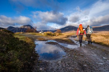 Hikers on a trek, Glen Coe Valley, Lochaber Geopark, Highlands, Scotland, United Kingdom clipart