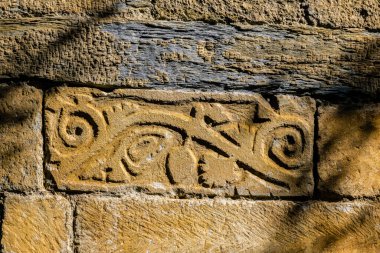 reliefs in the wall, church of Sant Felix de Vilac , Vilac , municipality of Vielha e Mijaran , Valle de Aran, cordillera de los Pirineos, Spain, europe clipart