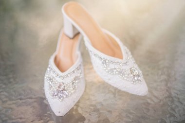 Wedding shoes with pointed toe. Footwear with high heels. Women feet in Luxury spring summer women's shoes. Female stylish slippers on the floor. Fashionable woman