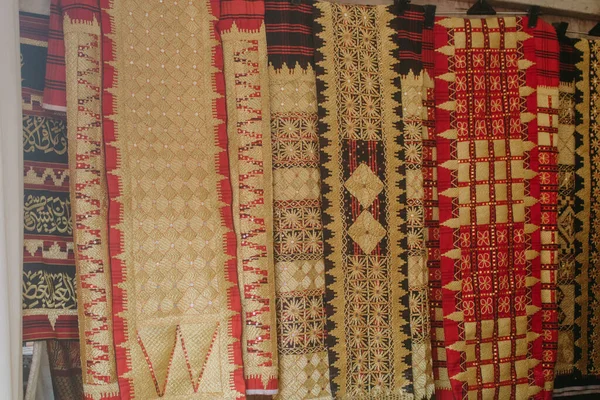 Fabric Various motifs. different fabrics displayed on the shelves. a fabric that can be called a typical tapis fabric from the province of Lampung in Indonesia.