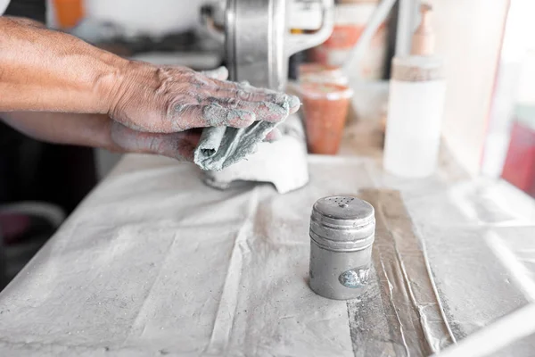 An adult tortilla maker is preparing a blue corn tortilla taco with salt to eat during a break. Concept of traditional corn tortillas preparation