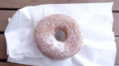 Zoom in of a sugar covered donut on top of a paper bag. Close up. Close up. Concept of LA local food