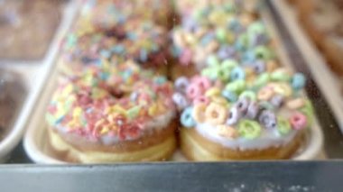 Fresh baked donuts covered with coloured sugar cereal and glazed sugar. Close up. Concept of Los Angeles traditional food