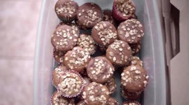 A stack of handmade oat muffins inside of a box recently delivered. Concept of sweet food delivered
