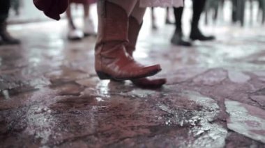 Close up of a woman practicing tap dance wearing classical boots. Concept of traditional folk music in Mexico