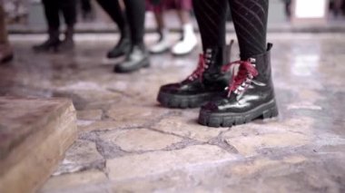 Close up of a woman practicing tap dance wearing urban black boots. Concept of traditional folk music in Mexico