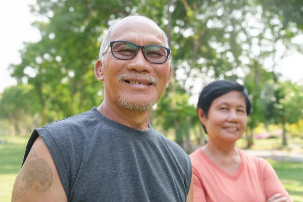 stock image Portrait of Happy and healthy Asian Chinese senior Couple at park outdoor. Mature man and Woman smiling relaxing, exercising.