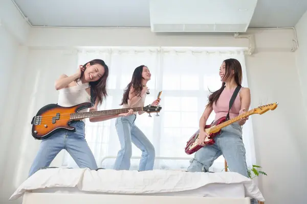 Grupa Pięknych Azjatek Gra Gitarze Elektrycznej Elektrycznym Basie Śpiewa Łóżku Zdjęcia Stockowe bez tantiem