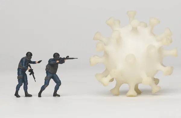 A picture of miniature anti terrorist and corona virus. Fighting the virus