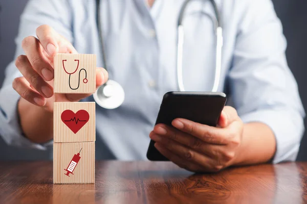 Doctor Holding Wooden Dice Icons Health Doctors Smartphone His Hands — Stock Photo, Image