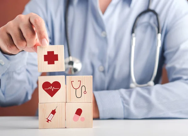 stock image Hand of doctor arranging wood blocks with healthcare medical icons. Space for text. Health and medical concept.