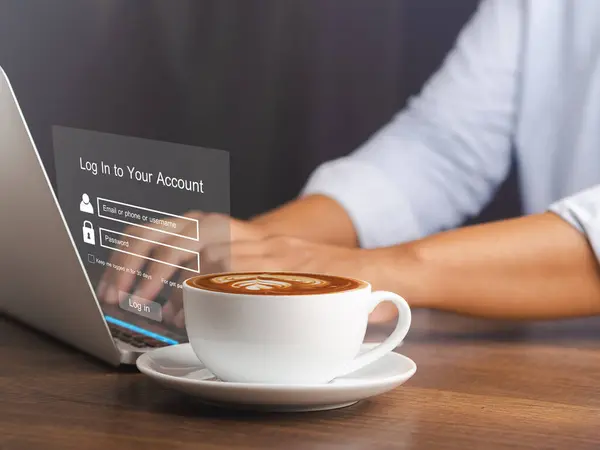 Cyber security concept. The login page on the virtual screen to the computer system on the laptop. A cup of coffee on the table. Business, technology, and networking conceptual.