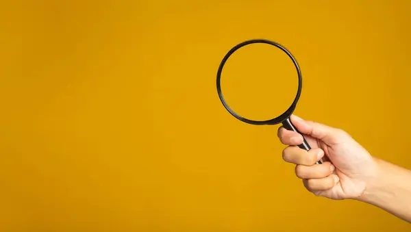 Hand Holding Magnifying Glass Yellow Background Copy Space Text Close — Stock Photo, Image
