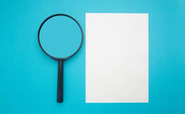 Top View Magnifying Glass Blank White Paper Isolated Blue Background — Stockfoto