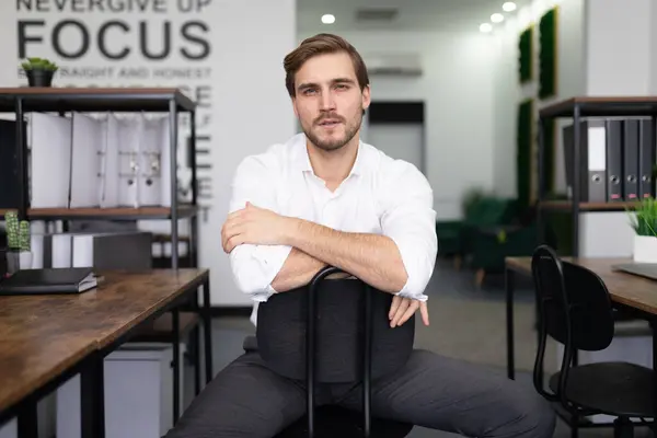 young man in business clothes for an interview sits on a chair.