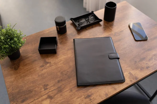 leather folder for documents on the desktop in the office.