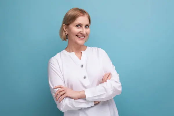 stock image blond bob middle-aged woman in a white blouse in menopause on a studio background.