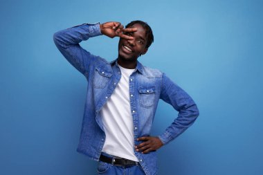 Kıvırcık saçlı, sıradan kot elbiseli, gülümseyen Amerikalı adam..