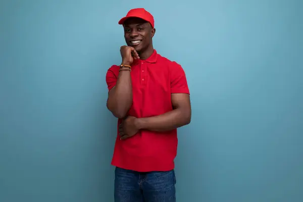 branded clothing concept. american man wearing a red t-shirt and cap on the background of ss copy space.