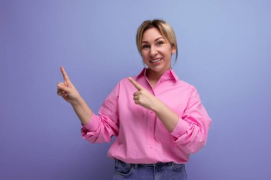 Pembe gömlekli güzel Avrupalı sarışın sekreter elini bir reklam teklifinin yanında fotokopi çekilen bir arka planda gösteriyor..
