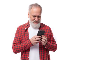 Mutlu, başarılı, 60 yaşında, sakallı, bıyıklı, beyaz saçlı emekli adam. Telefon tekniği..