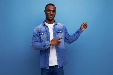 Kot ceketli yakışıklı Amerikalı adam mavi arka planda fotokopi aletiyle el ele geziyor..