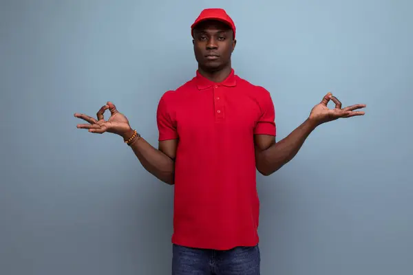 clothing for identity and branding. successful young handsome american man in red t-shirt and cap.