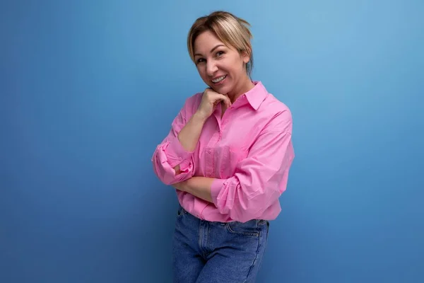 stock image smiling businesswoman in pink shirt on studio background with copy space.