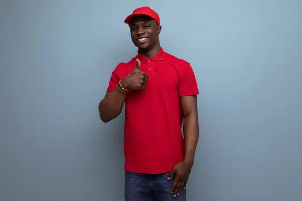 branded clothing concept. american man wearing a red t-shirt and cap on the background of ss copy space.