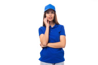 Güzel, güzel, beyaz tenli, esmer kadın üniformalı, beyaz ilan panosu arka planında şapka takıyor..