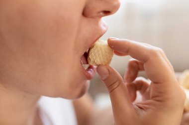 Bir kadın waffle kekini ağzına tıkar. Kilo alma ve diyet yetmezliği kavramı.