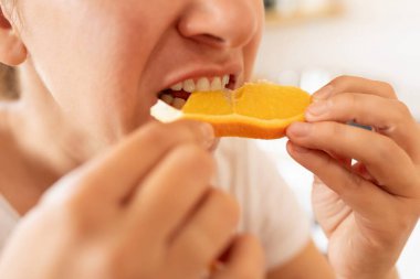 Sabahları kahvaltıda portakal yiyen bir kadın..