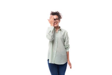 Gülümseyen esmer, kıvırcık saçlı, beyaz arka planda ekose gömlek giyen kadın..