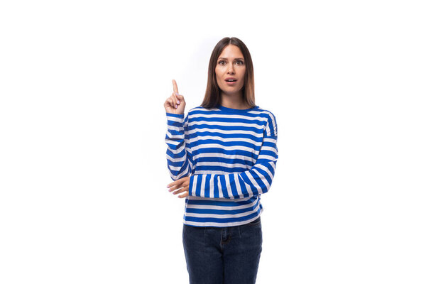 young european brunette woman dressed in striped blue clothes gives interesting news.