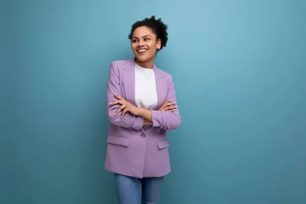 young successful latin business woman dressed in lilac jacket isolated studio background with copy space.