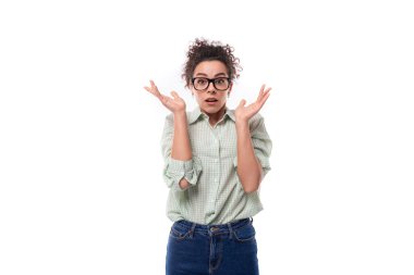 Kıvırcık siyah saçlı, kendine güvenen bir lider kadın gözlük takıyor..