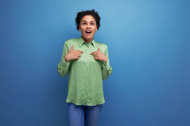 Arka planda yeşil bluz ve fotokopi alanı olan parlak Latin bir kadının portresi..