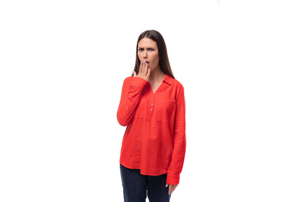 young pretty brunette leader woman with long hair dressed in a red blouse on a white background with copy space.