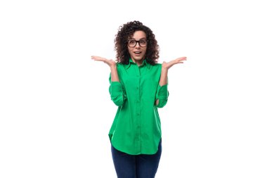 Siyah kıvırcık saçlı, yeşil gömlekli hoş bir genç kadın..