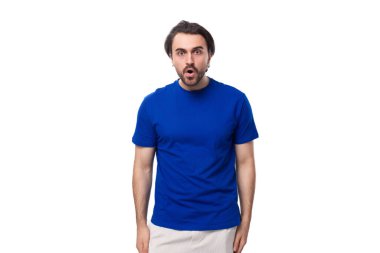Siyah saçlı ve sakallı, mavi tişörtlü yakışıklı Avrupalı genç adam..