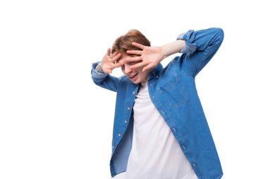 Beyaz arka planda kırmızı saçlı, kırmızı saçlı, şaşırmış genç bir adam..