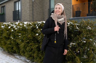 Sarışın bir kadın kışın şehirde yürüyor..