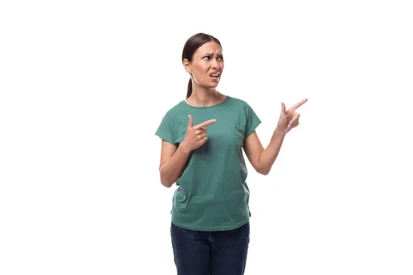Active Smiling Young Caucasian Brunette Woman Green Shirt Points Her — Stock Photo, Image