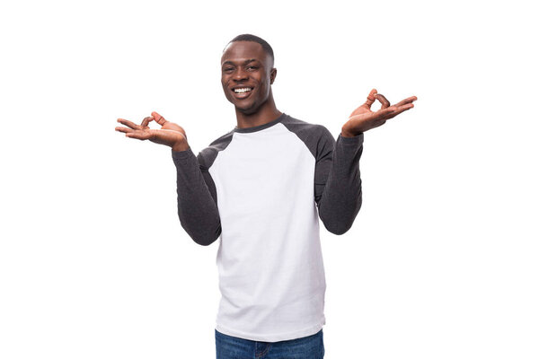 Young charismatic african man dressed casual smiling on white background with copy space.