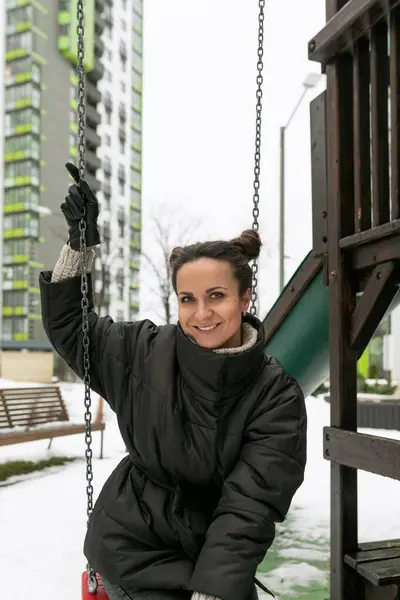 stock image European young woman enjoying a walk in the playground.